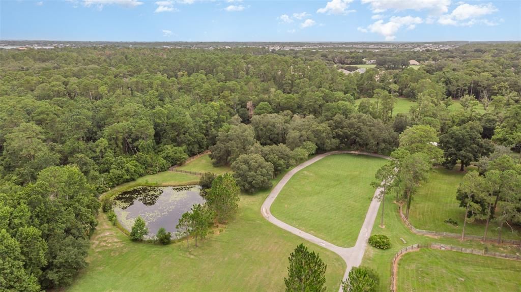 Aerial view of pond at front of property