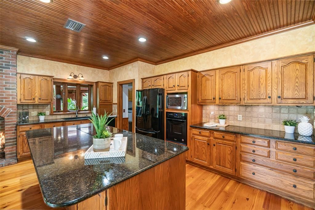 Kitchen with built in oven and refrigerator in center of frame