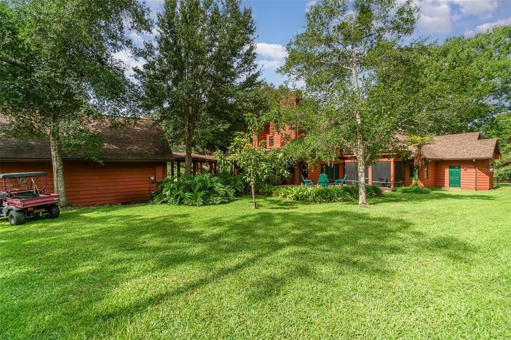 Another view of the rear of the home with the Breezeway and Firepit at the center of the frame