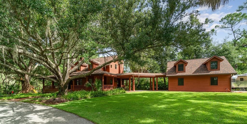 View from Driveway at Breezeway flanked by twin oads with garage to the right of frame