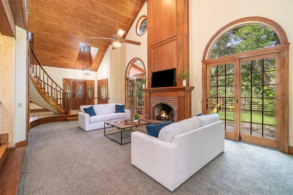 Great Room with wood burning Fireplace and twin sliding French Doors