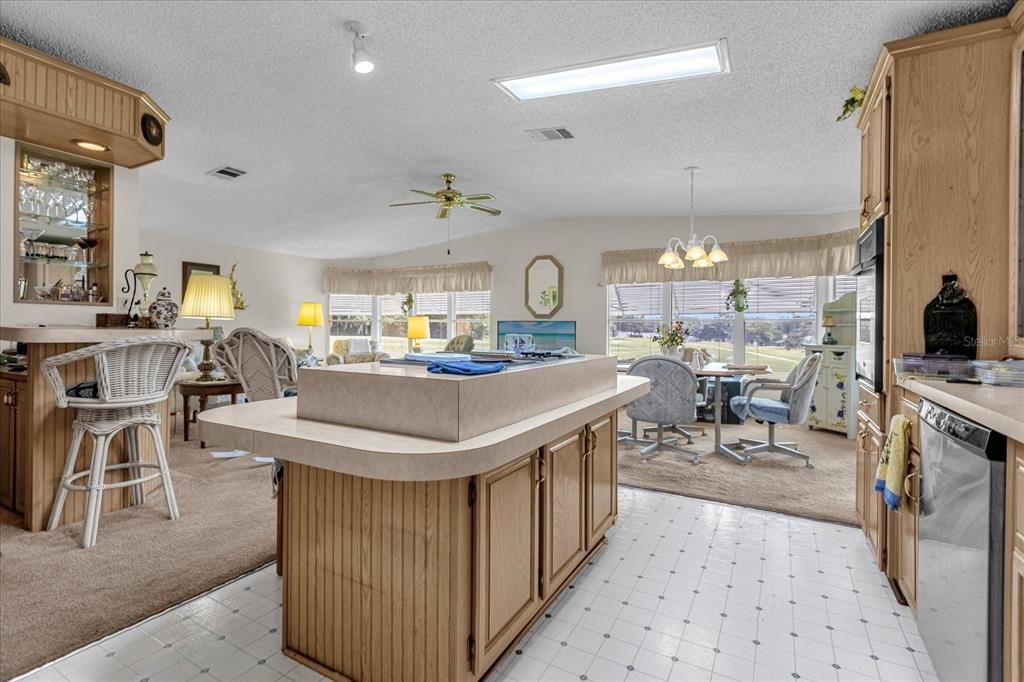 Kitchen view into Eat-In/Family Room & Wet Bar