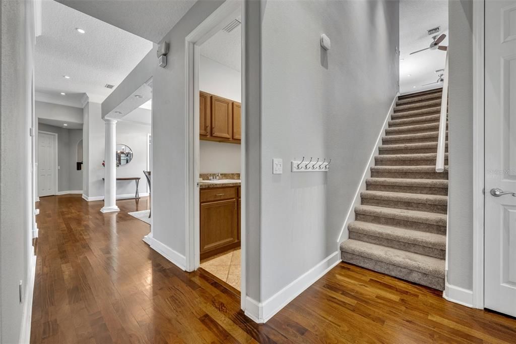 Hallway with access to laundry and stairs to bonus and additional bedroom and bath