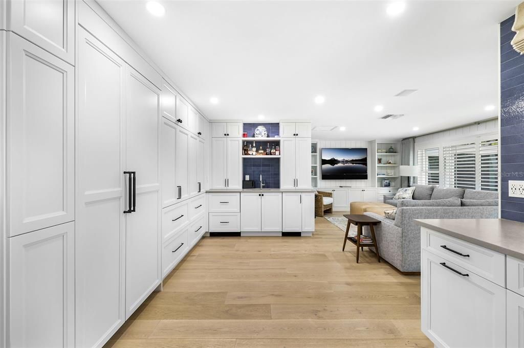 Kitchen with hidden appliances and wet bar