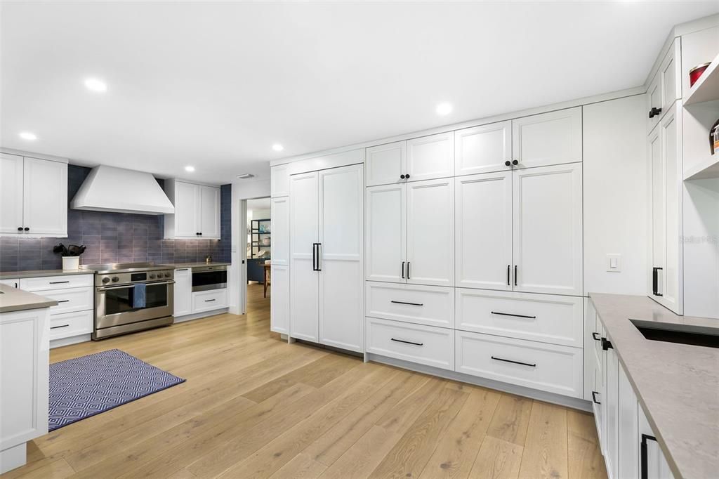 Modern kitchen with hidden appliances and wet bar