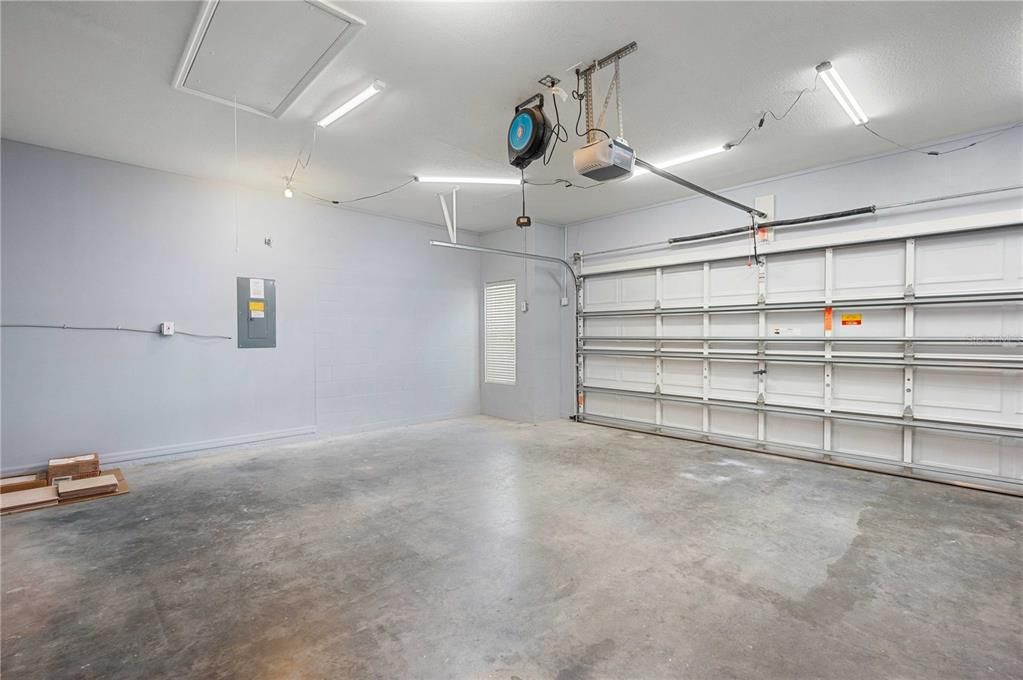 Freshly painted garage with attic storage.