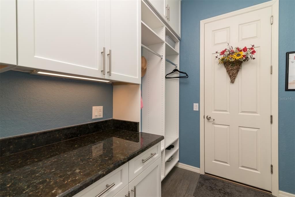 The "flex" room has built-in cabinetry that extends to the ceiling. Soft close doors and drawers and granite countertop are a plus. The extra storage will be most appreciated.