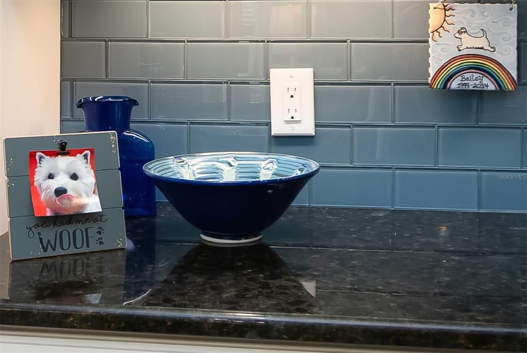 The glass tile backsplash adds a major touch of class to the entire kitchen.