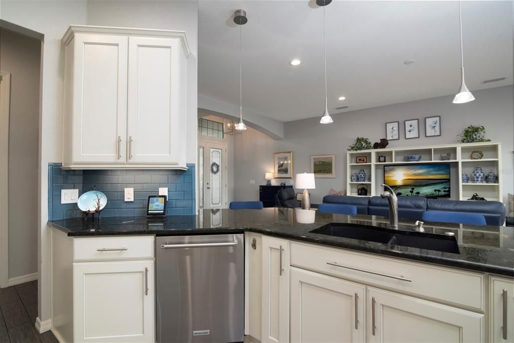 The kitchen layout is very friendly when entertaining and enhances the openness of this floor plan. The ample cabinetry has custom pulls.