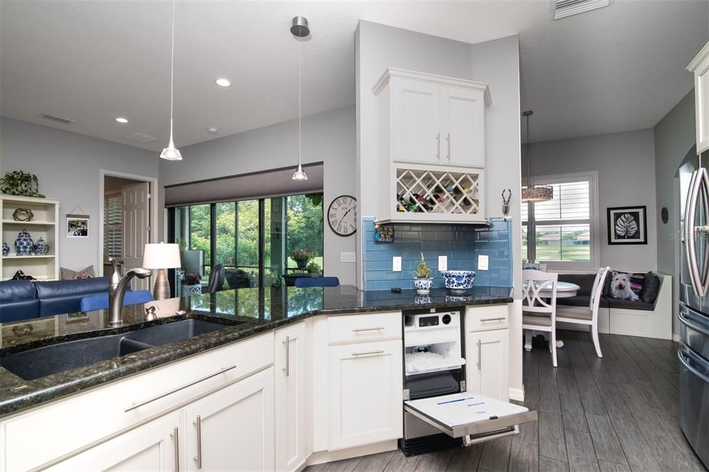 The cabinet wine rack is above the built in ice maker.