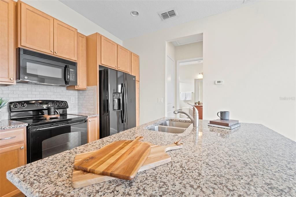 Above Garage Apartment Open Concept Kitchen with Island and Interior Laundry.