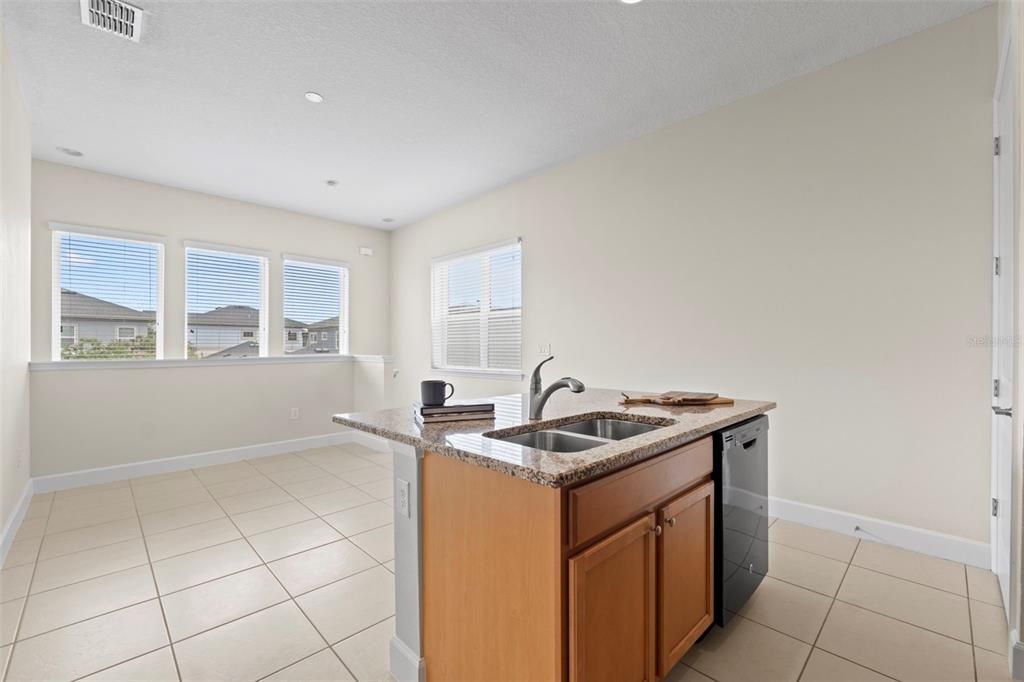 Above Garage Apartment Open Concept Kitchen with Island and Interior Laundry.