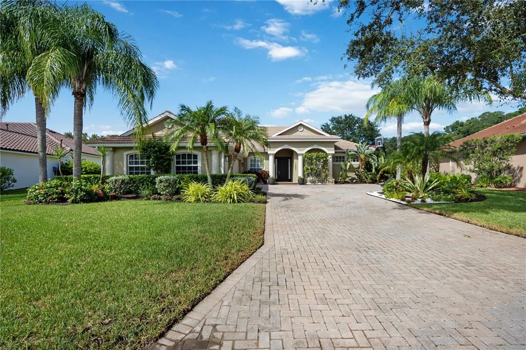 Surrounded by lush Florida Palms, upgraded landscaping and landscape lighting.