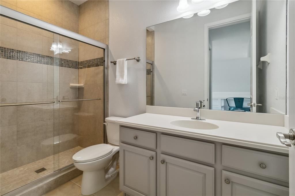 Upstairs third bathroom with modern shower.