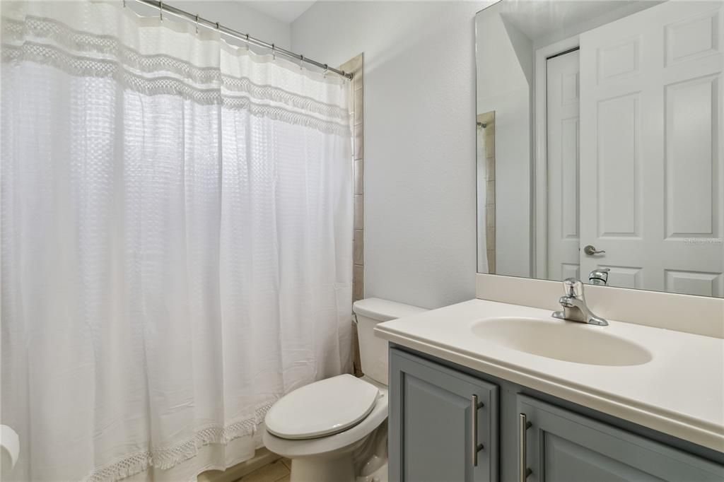 Second bathroom shared between bedroom two and three with oversized walk in linen closet, shower and tub.