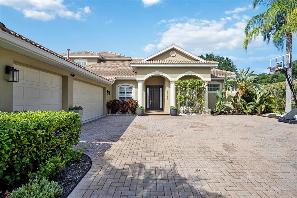 Oversized brick paved driveway leading into impressive 3- car side garage offering ample space and convenience. Epoxy floor coating 2023. Charge your electric vehicle with 60 AMP EV charger already installed.