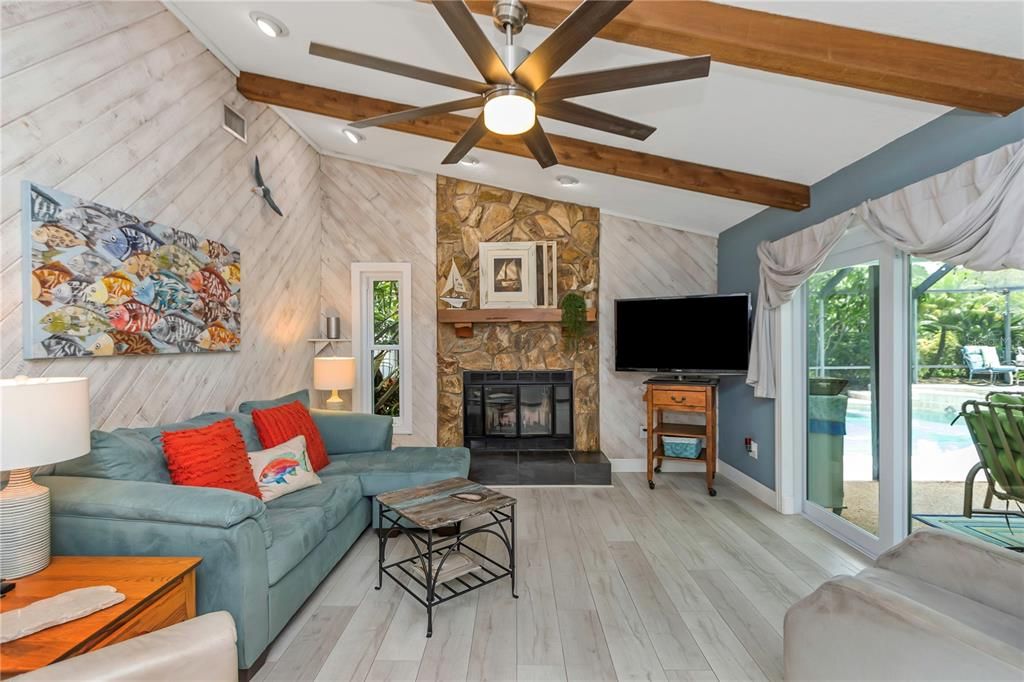 Family Room with Wood Burning Fireplace and High Impact Sliders to the Pool