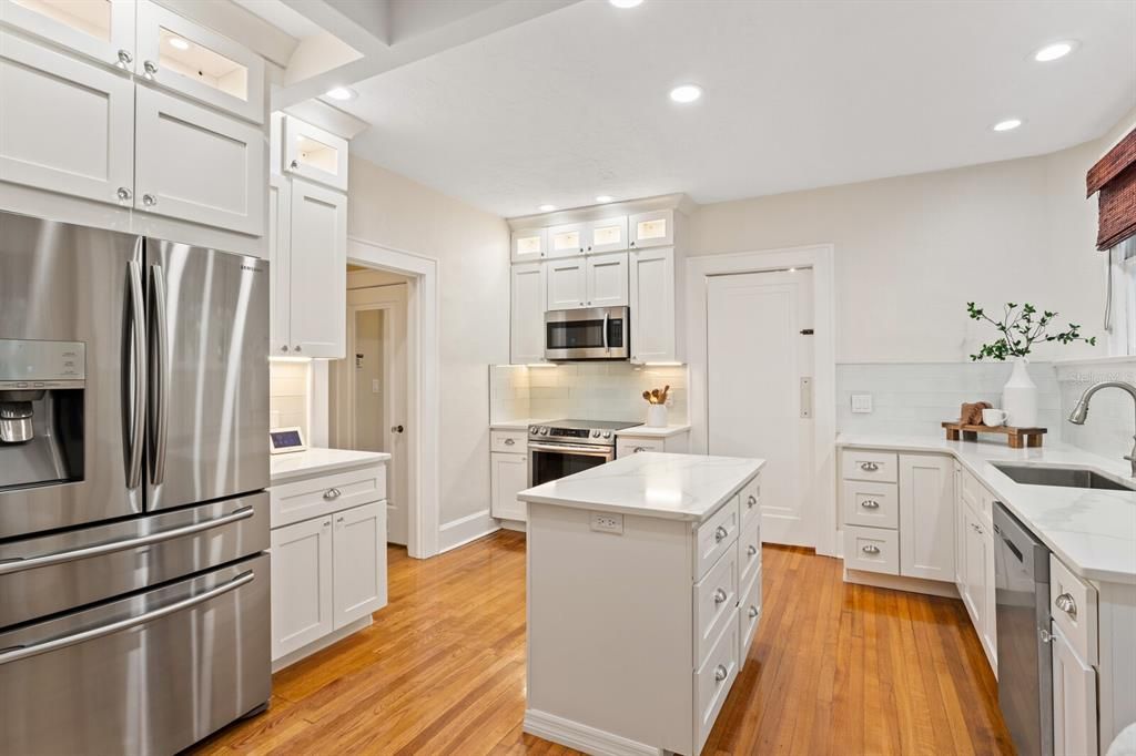 Stunning kitchen with center island and cabinetry with light features.