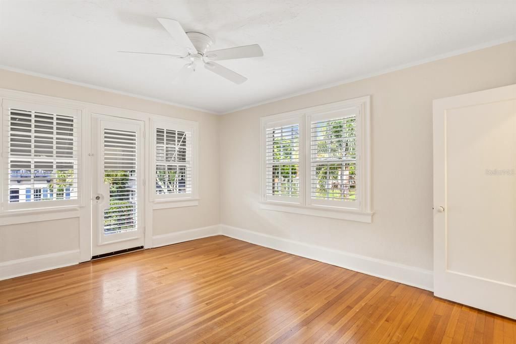 Upstairs, front bedroom features a decorative iron balcony off the front of the home.