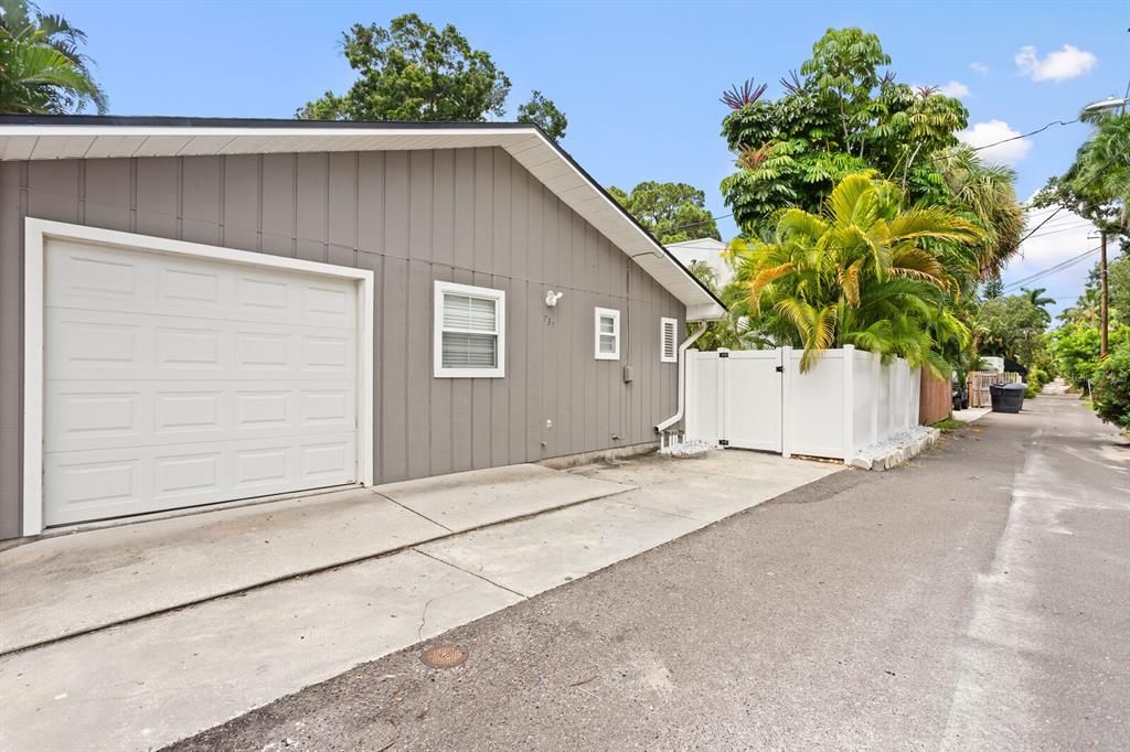 One-car garage with large parking pad space for another vehicle.