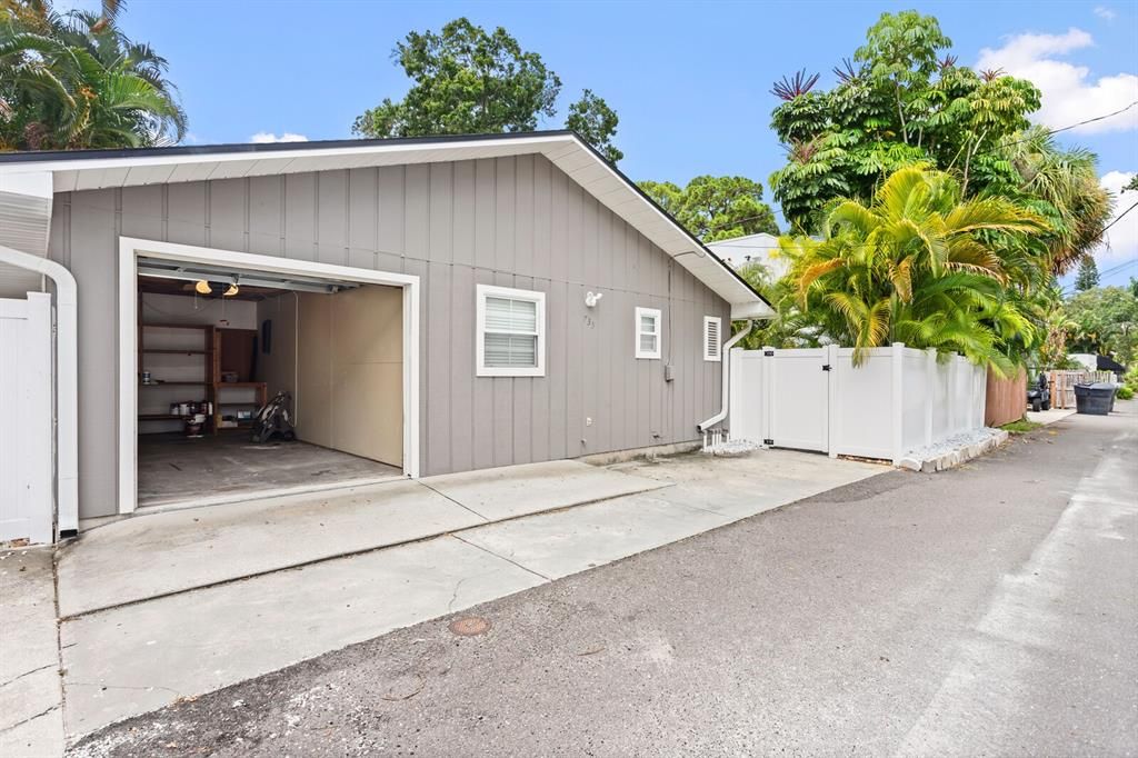 Private garage and large paved alley.