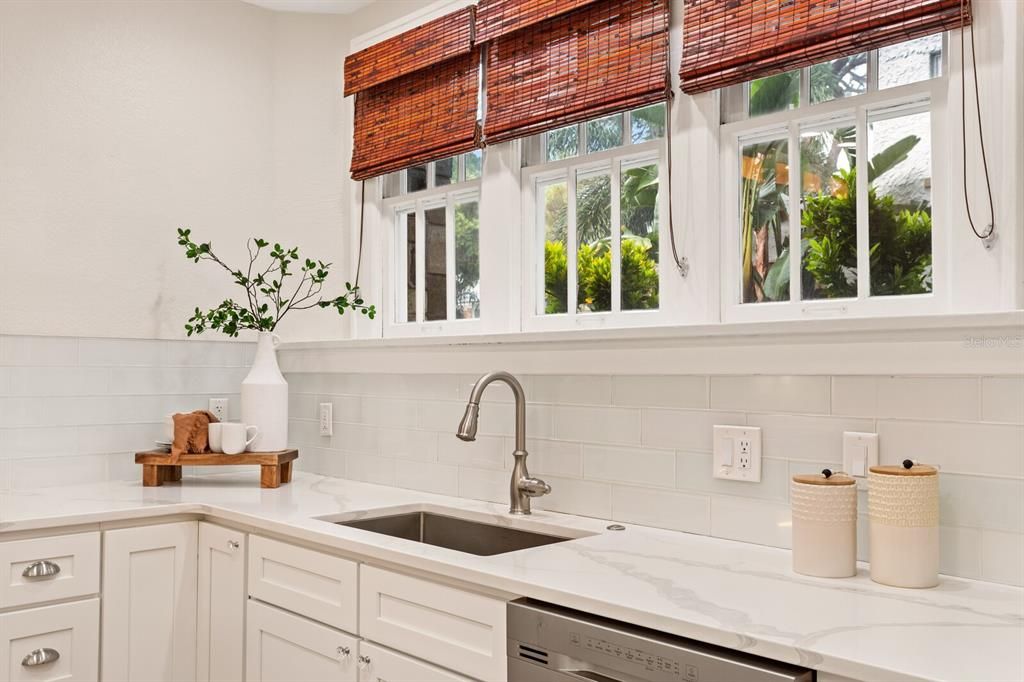 Beautiful Roman shades throughout the kitchen.