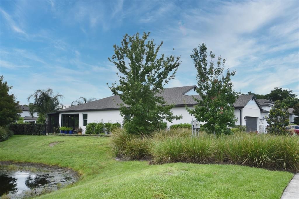 Side view of home, adjacent to pond