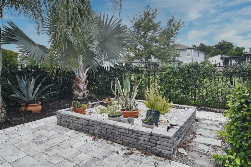 Stone, raised planter box in backyard