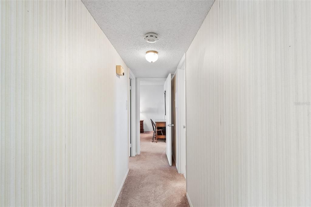 HALLWAY TO 2ND BATHROOM AND PRIMARY BEDROOM