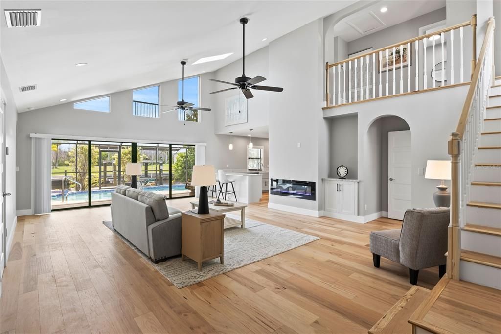 HUUUUUGE Living room with high vaulted ceilings, a wall of sliders and lots of natural light throughout!  Total care and top upgrades were used when remodeling this beauty and it is apparent everywhere!