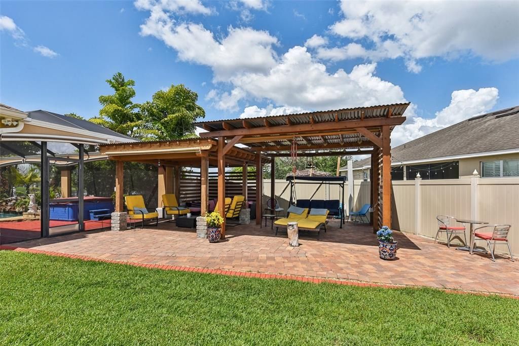 Part of the Backyard. 2 very nice Pergola's with roofs and lots of shade!