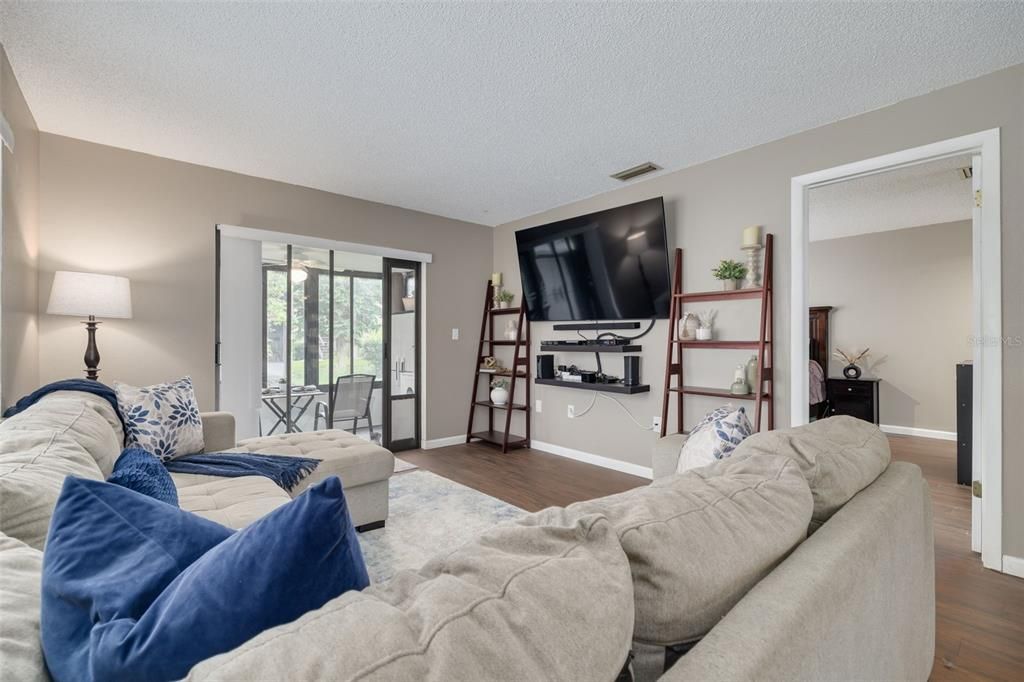 Living room with door to primary bedroom