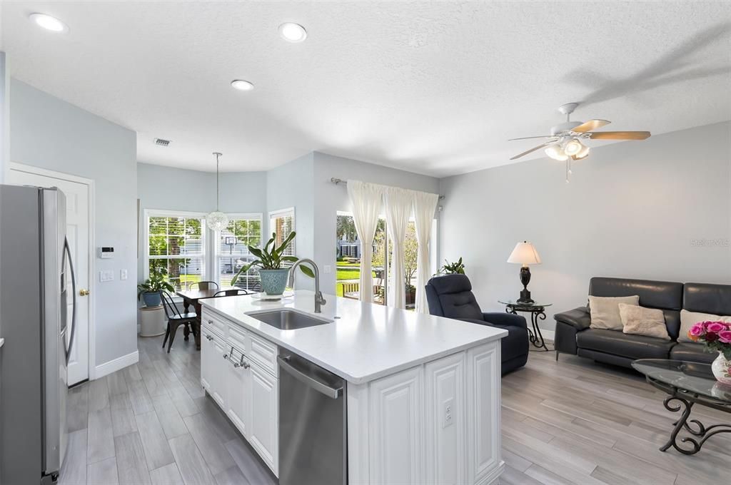 The Stunning Gutted/Renovated Kitchen Features Newer Stainless Steel Appliances (Brand New Dishwasher), Quartz Counters, Breakfast Bar and Dinette area.