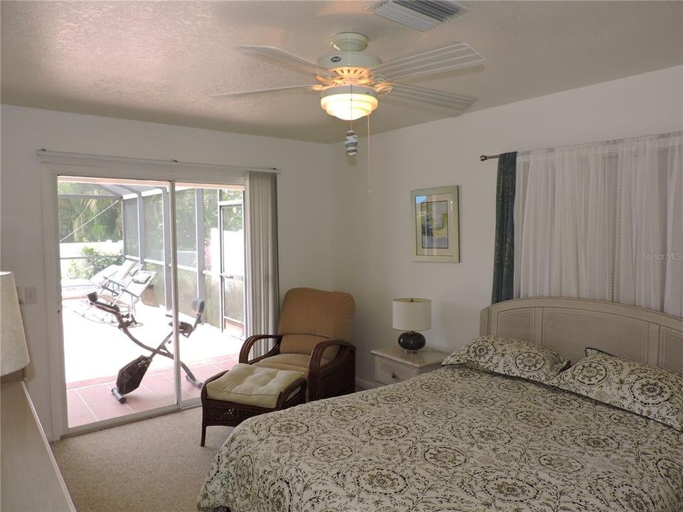 Master Bedroom with sliders to pool and Lanai