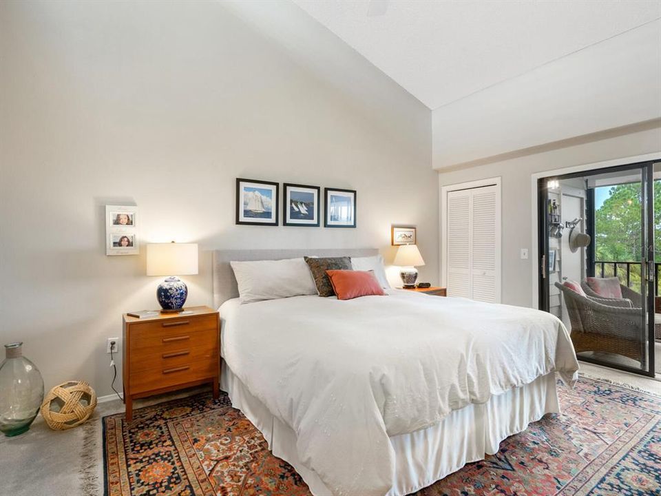 Primary bedroom: more vaulted ceilings (& clerestory window), small additional closet and view of canal