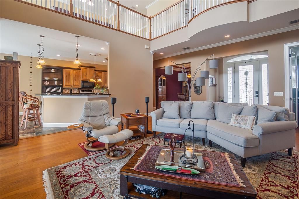 Living room with kitchen and dining room in view.