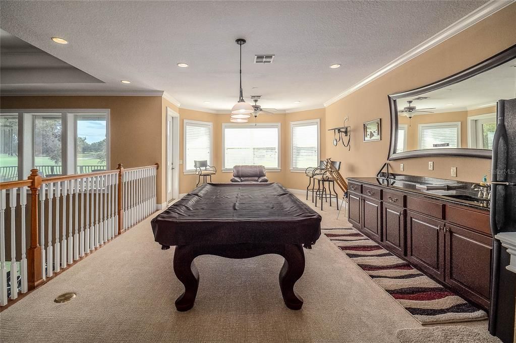 This can be a bonus room or enjoy the pool table the owners will leave for the buyers enjoyment.  The wet bar area is great for entertaining and a full size refrigerator to store your essentials.