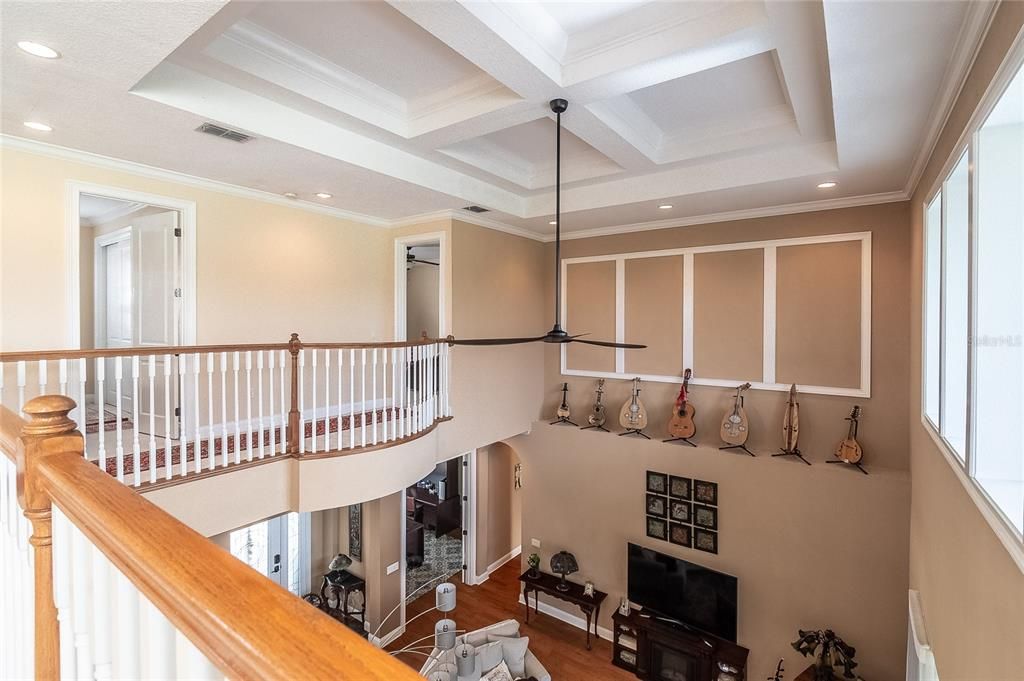 Upstairs looking from game/bonus room over living room. Notice the beautiful tray cut ceiling, accent recessed lighting and crown molding.