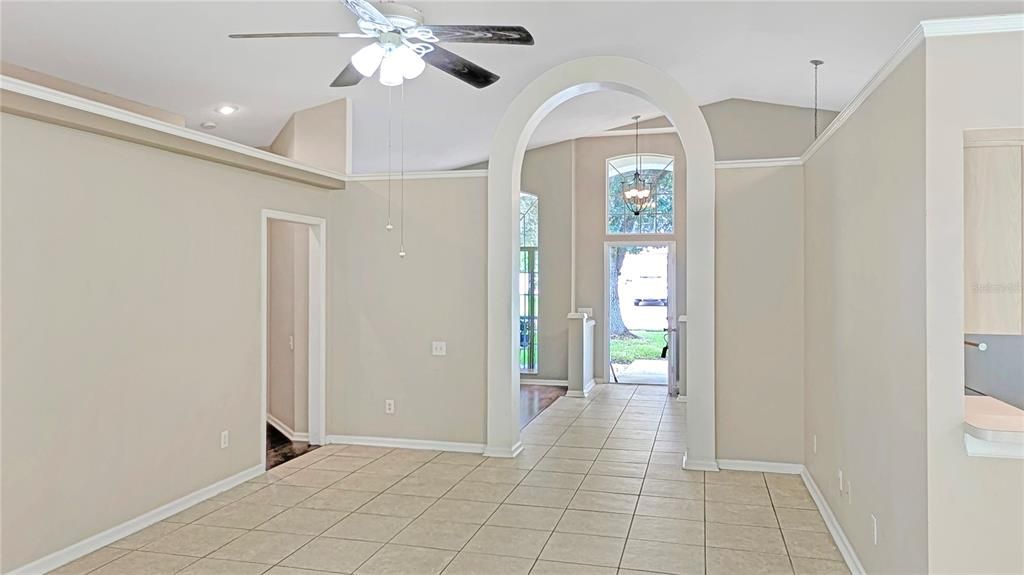 Family Room looking towards Entrance Foyer with your Back to your Covered Lanai! Flexible Floorplan with Formal Living and Dining Rooms AND a Family Room Separated by a Dramatic Interior Arch!