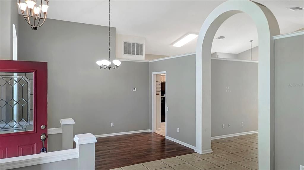 Formal Dining Room as seen from Formal Living Room! Flexible Floorplan with Formal Living and Dining Rooms AND a Family Room Separated by a Dramatic Interior Arch