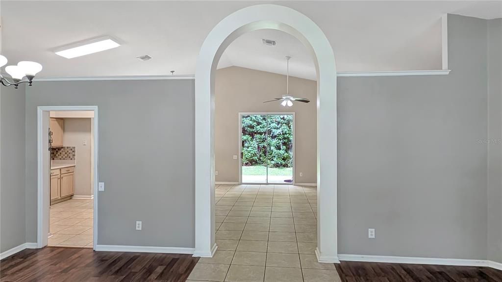 Family Room thru Arch and Kitchen on the Left as seen from Entrance Foyer! Flexible Floorplan with Formal Living and Dining Rooms AND a Family Room Separated by a Dramatic Interior Arch