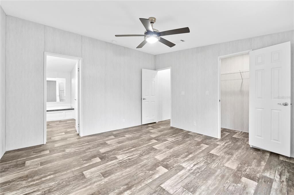 Primary Bedroom w/ view of En-Suite Bathroom & Walk-In Closet