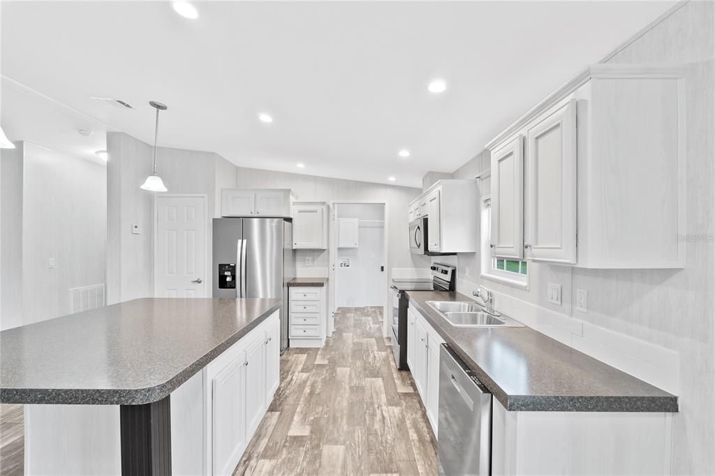 Kitchen w/ view of Laundry Room