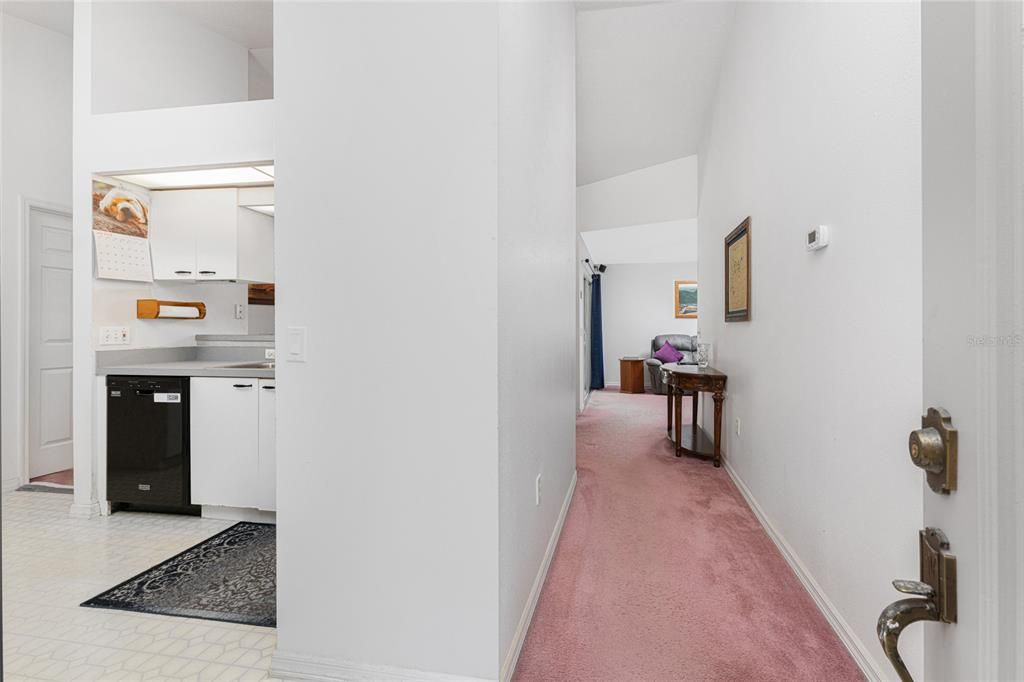 Foyer entry leads you to either the kitchen on the left or the living room ahead.