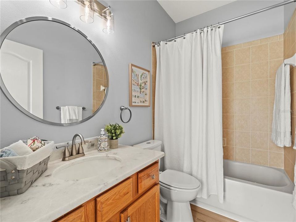 Guest bathroom for home or specifically for the second primary bedroom offers a suite-like design.  Immediate access to kitchen and family room.