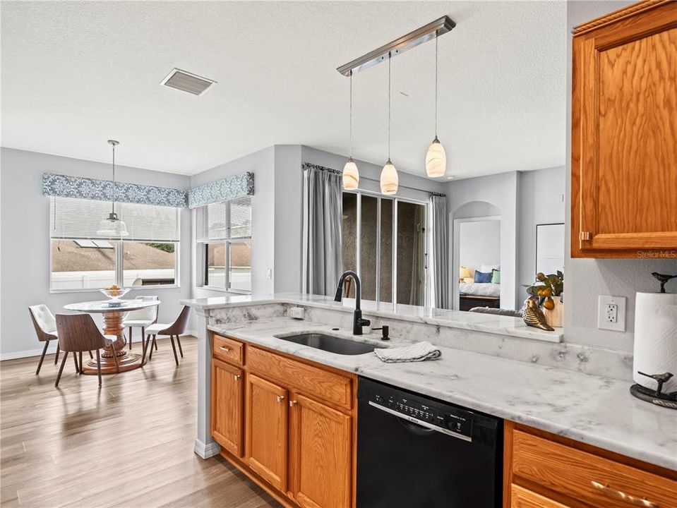 Enjoy your kitchen that opens to family room and eat in kitchen space, with oversized windows and sliding glass doors that stream Florida breezes and sunshine throughout the home