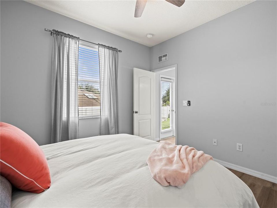 Bedroom 2 or better described as a second primary bedroom suite, with bathroom in the adjacent suite hallway.