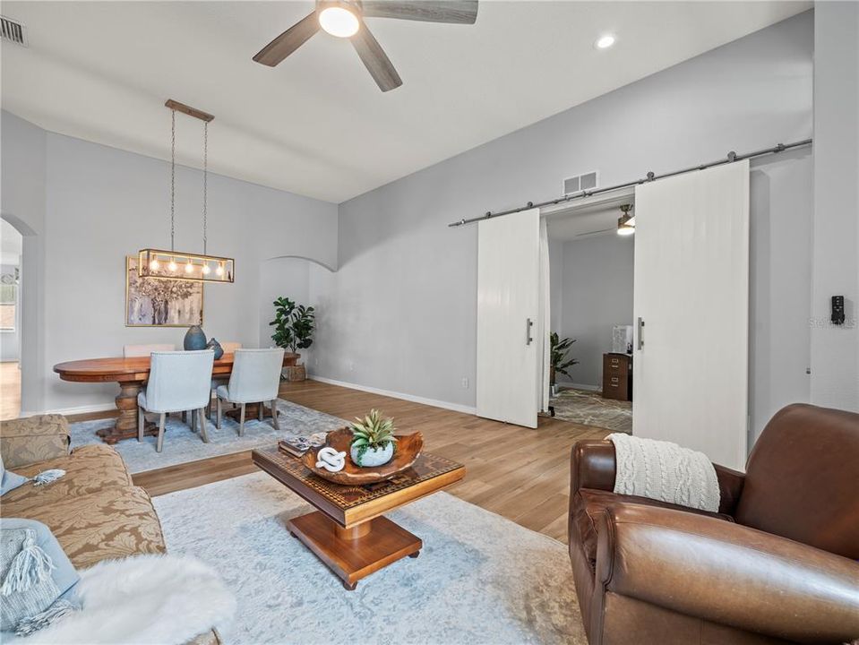 Oversized combination living room and dining room showing view with bonus room