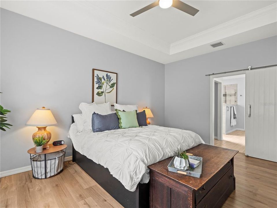 Ensuite bathroom in the primary bedroom with custom barn door opens to a custom renovated bathroom escape!