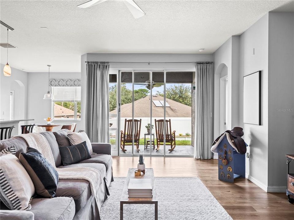 A family room with a view!  Open the sliding doors to enjoy the Florida outdoors.*Pet door sliding door panel does not convey